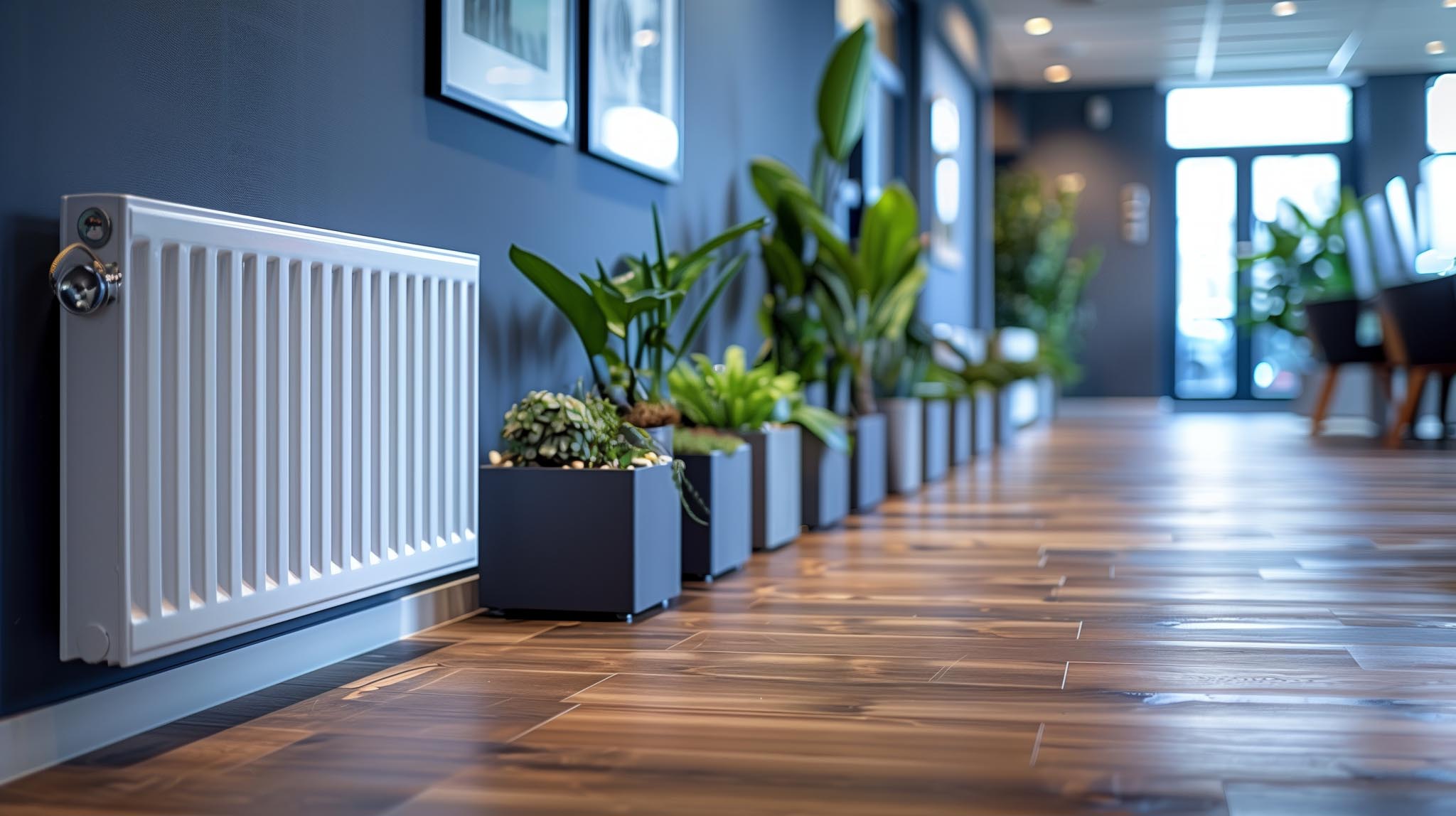 White Radiator in Modern Office Hallway With Plants and Hardwood Flooring